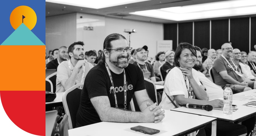 Attendees smiling at a presentation